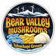 Logo for Bear Valley Mushrooms with mushrooms and mountains on a circular design.